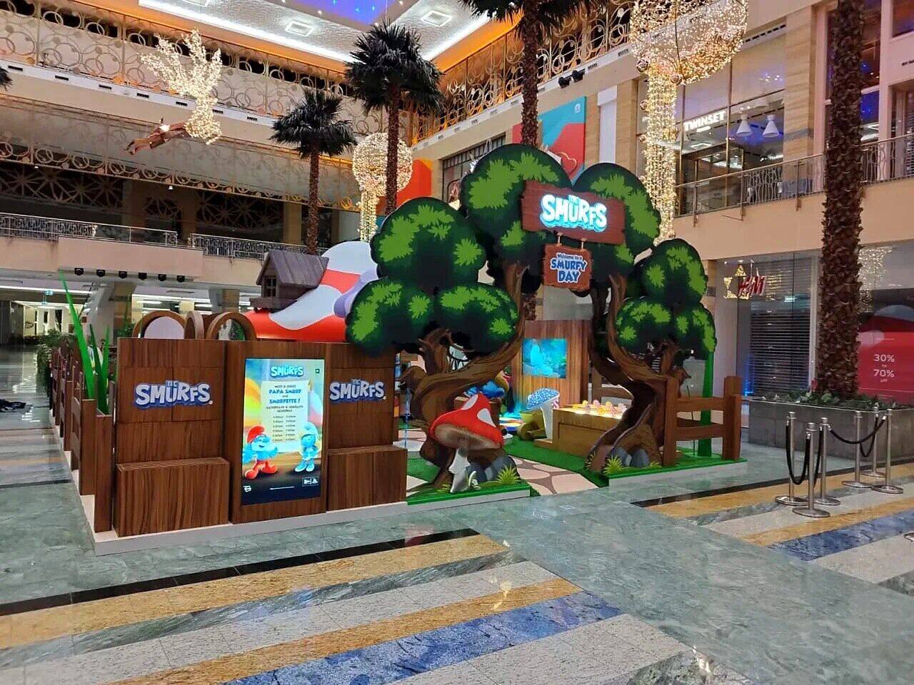 The Smurfs mall activation, themed village, trees, mushroom house, photo spots, display tables